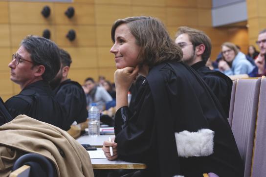 Femme avec une toge d'avocat au procès simulé du Fil rouge de droit